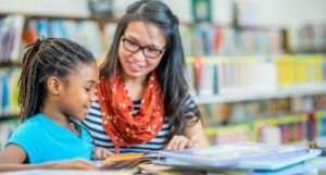 librarian helping a student in a library
